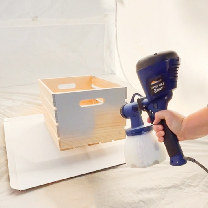painting crates with a sprayer